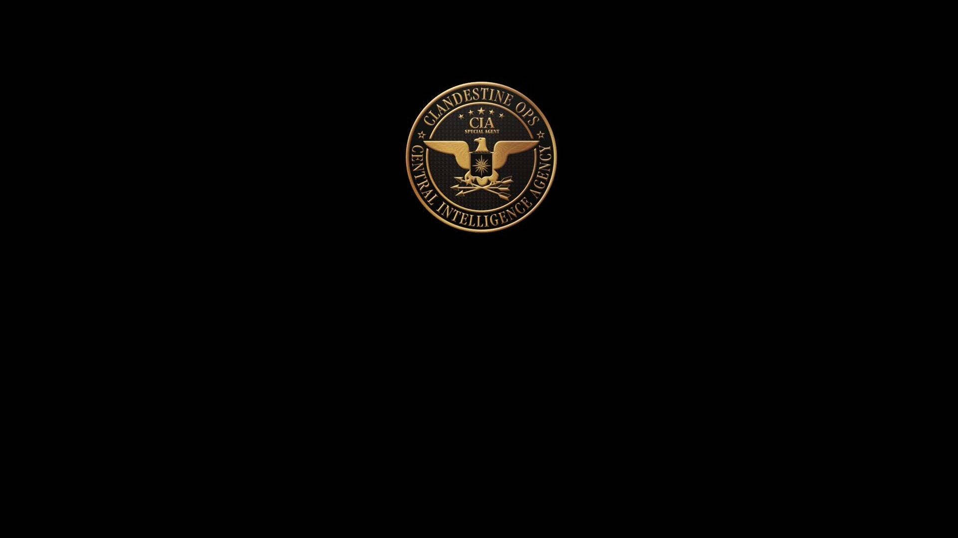 金黑配色中情局標誌 壁紙 — 一個金色的CIA秘密行動印章在純黑背景上閃耀，帶有銳利的金屬細節。