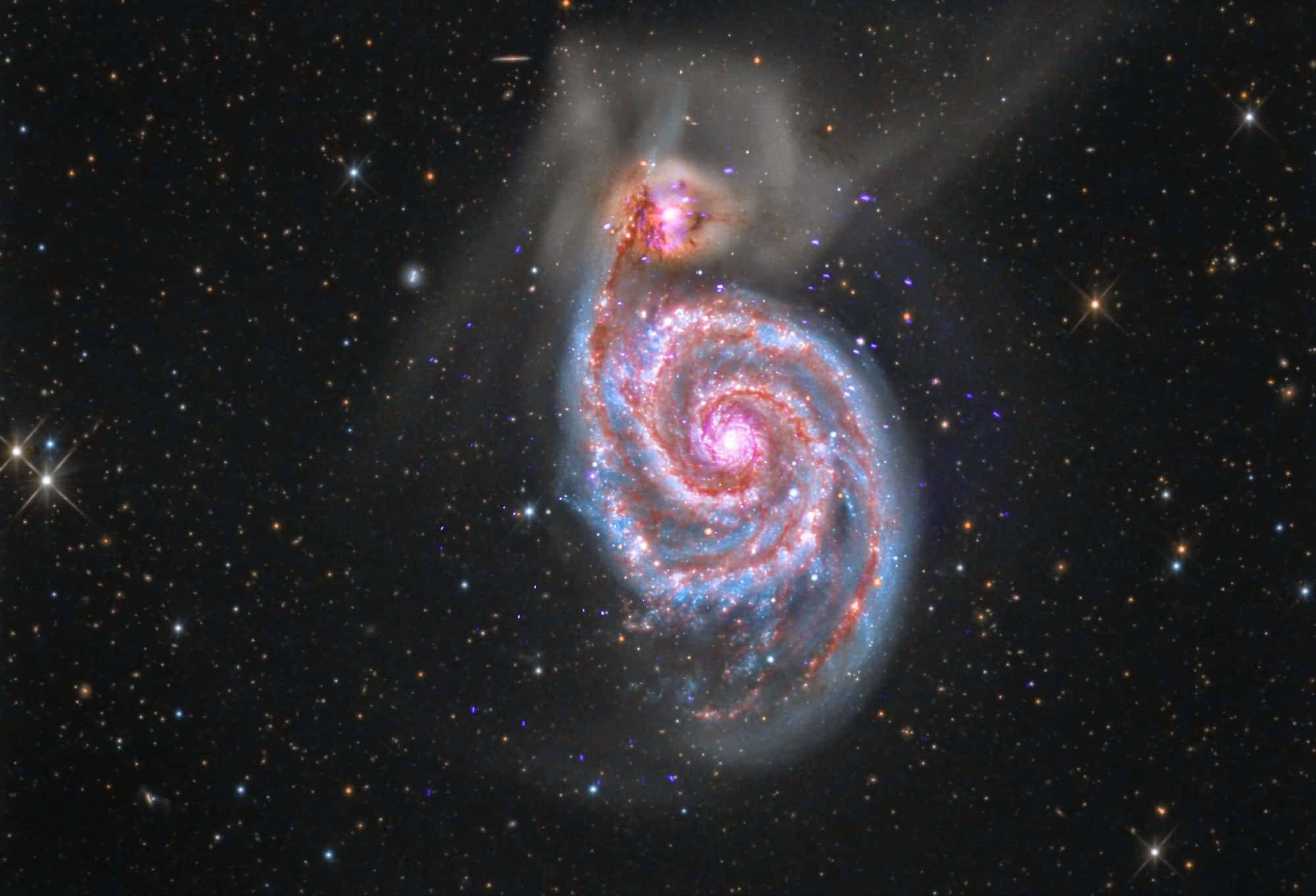 銀河系的超凡視角 壁紙 — 一個令人驚嘆的螺旋星系在星空背景下旋轉，呈現粉紅色和藍色色調。