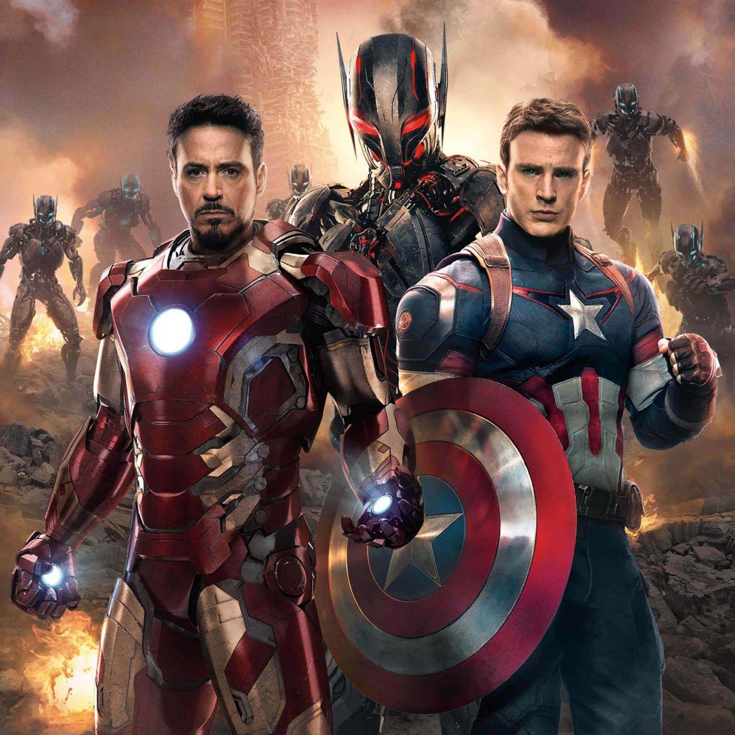 Iron Man Vs Captain America 桌布 壁紙 — 鐵甲奇俠和美國隊長在烈火戰場上堅定站立，蟻人和其他裝甲英雄在他們身後。