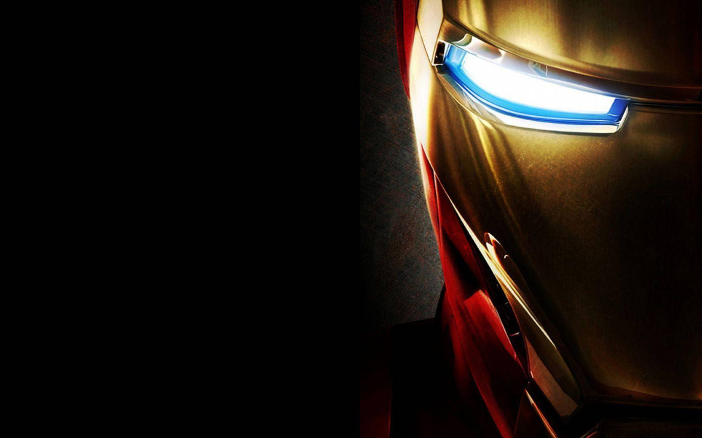 tony stark 桌布 壁紙 — 鐵甲奇俠發光藍色眼睛的特寫，背景黑暗，帶有金屬金色和紅色裝甲。