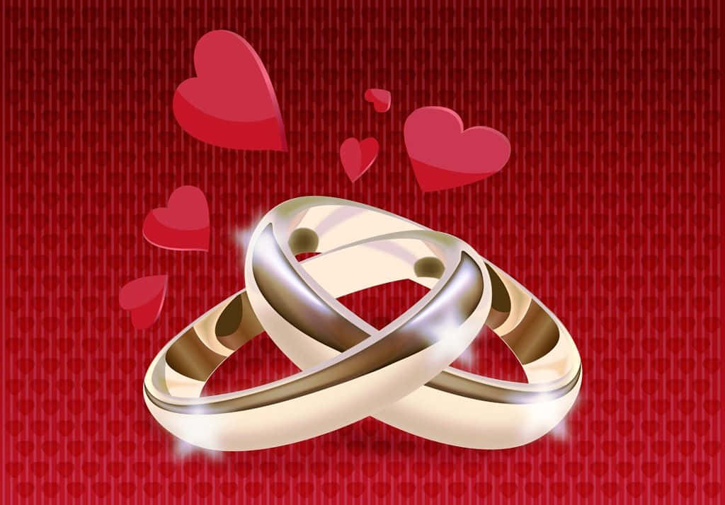 兩個交織的金色結婚戒指，在紅色心形圖案背景上漂浮著心形。