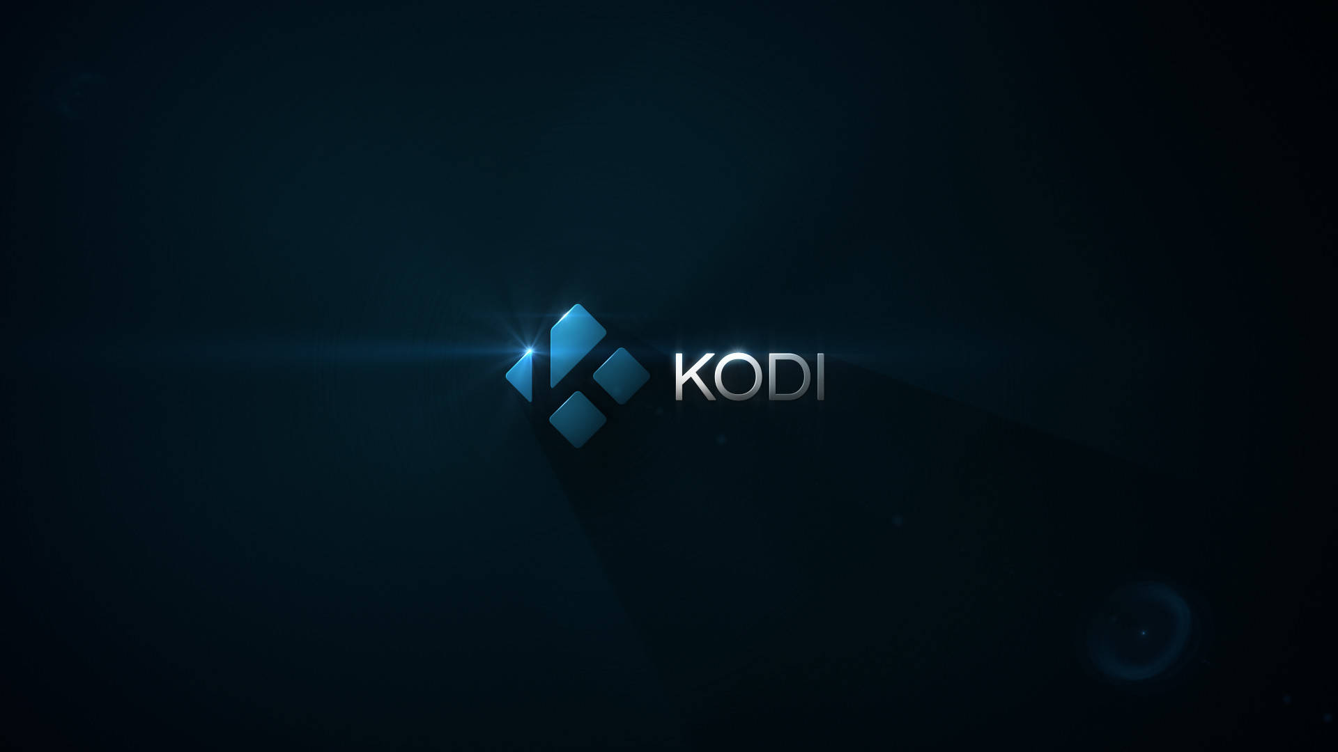 Kodi 媒體播放器標誌，在黑暗背景上帶有藍色光芒和鏡頭光暈。