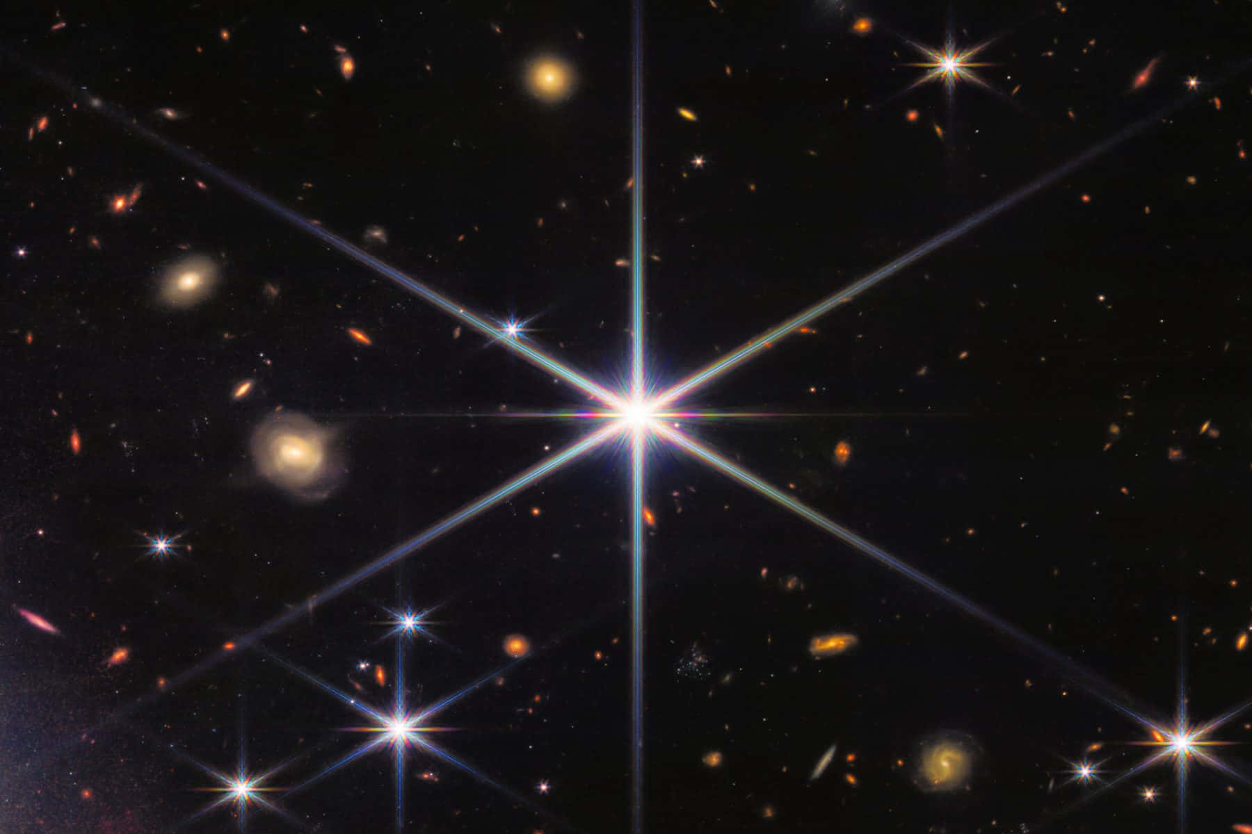 閃爍的星星照亮午夜天空 壁紙 — 一個明亮的星暴星系在黑暗的宇宙場中散發出強烈的光芒，場中點綴著遙遠的星系和恆星。
