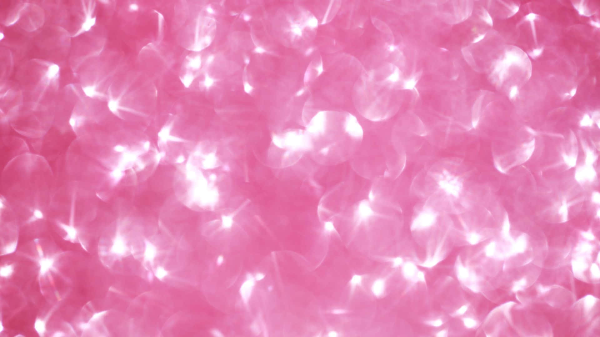 Pink Sparkles 桌布 壁紙 — 閃爍的粉紅色背景，帶有發光的散景燈光，營造出夢幻而光彩奪目的抽象圖案。
