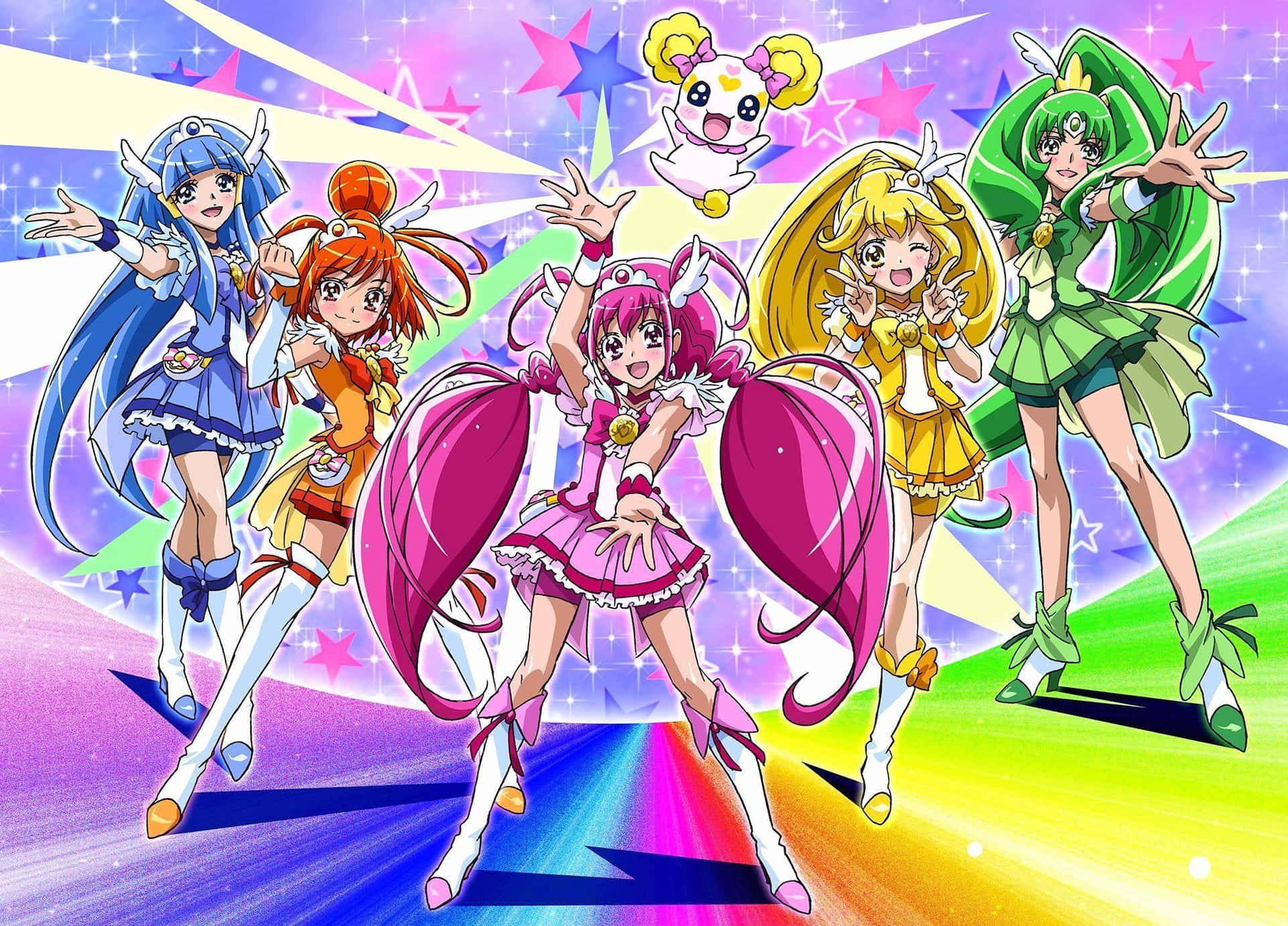 五個穿著魔法服裝的動畫女孩在閃光和彩虹背景下擺姿勢。