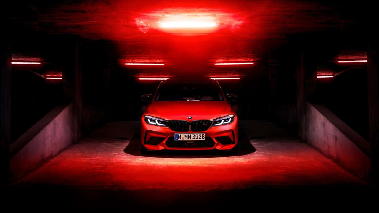 開闊道路上的迷人藍色寶馬 壁紙 — 一輛引人注目的紅色BMW M3停放在燈光昏暗的地下停車場，沐浴在強烈的紅色環境照明中。