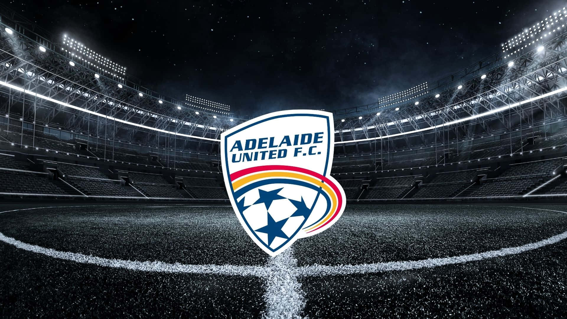 Adelaide United 桌布 壁紙 — 阿德萊德聯足球會標誌在球場中央，於球場燈光下，以繁星點點的夜空為背景發光。