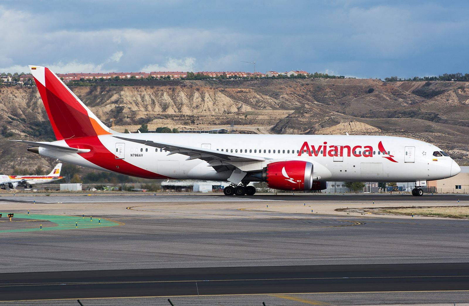 Avianca飛機在乾燥山丘附近的機場跑道滑行。