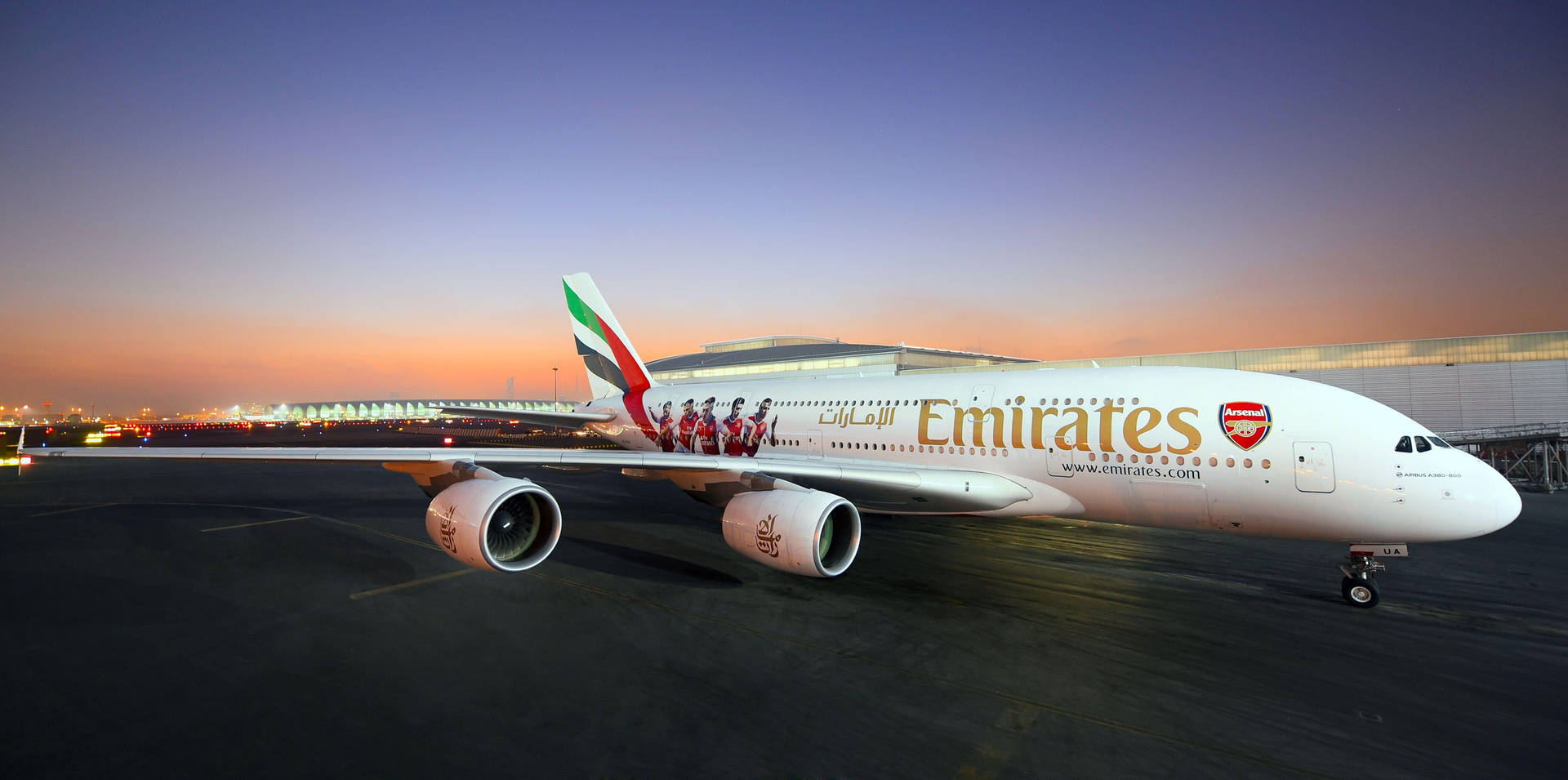 阿聯酋航空空中巴士A380披上阿仙奴塗裝，在日落時分的機場停機坪上。