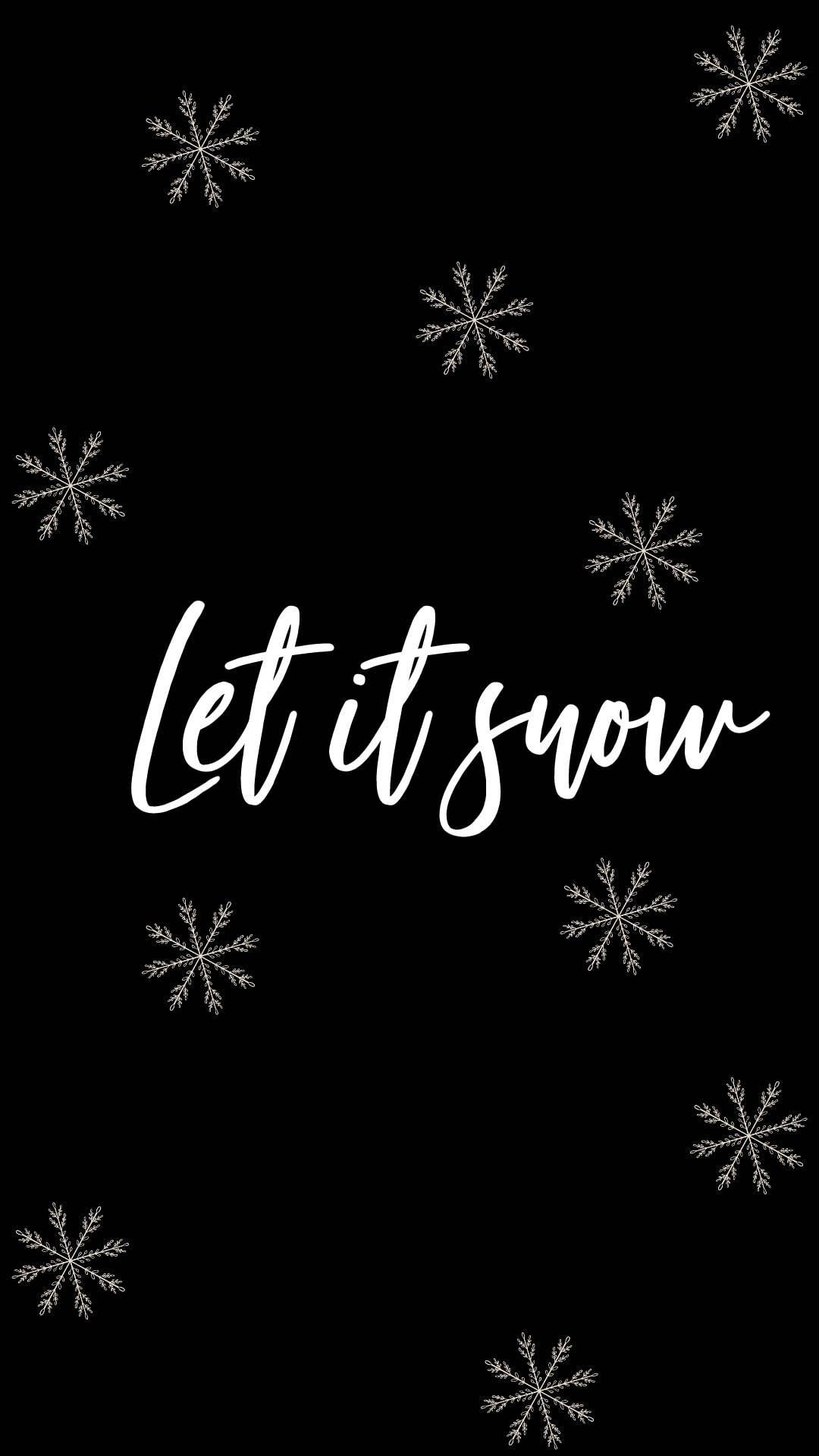 雪花和文字 let it snow 在黑色背景上