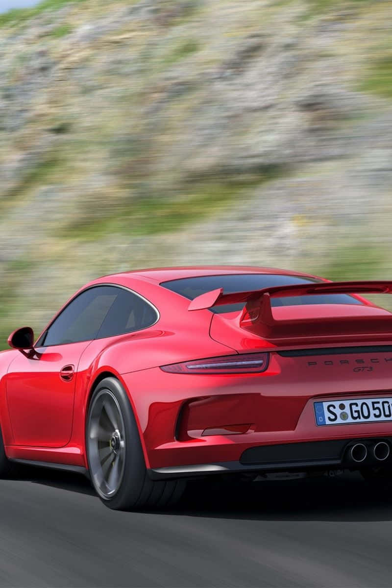 紅色保時捷911 GT3在日落時分於山路高速行駛