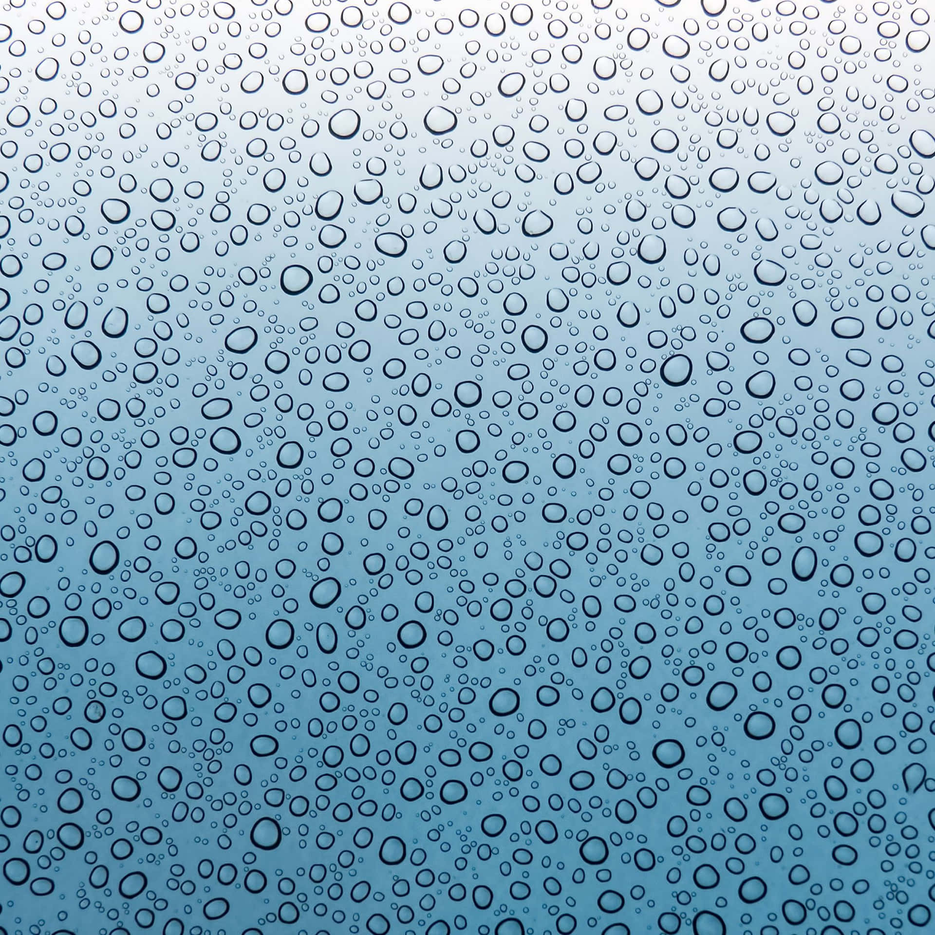 玻璃上的水滴，藍色漸變背景