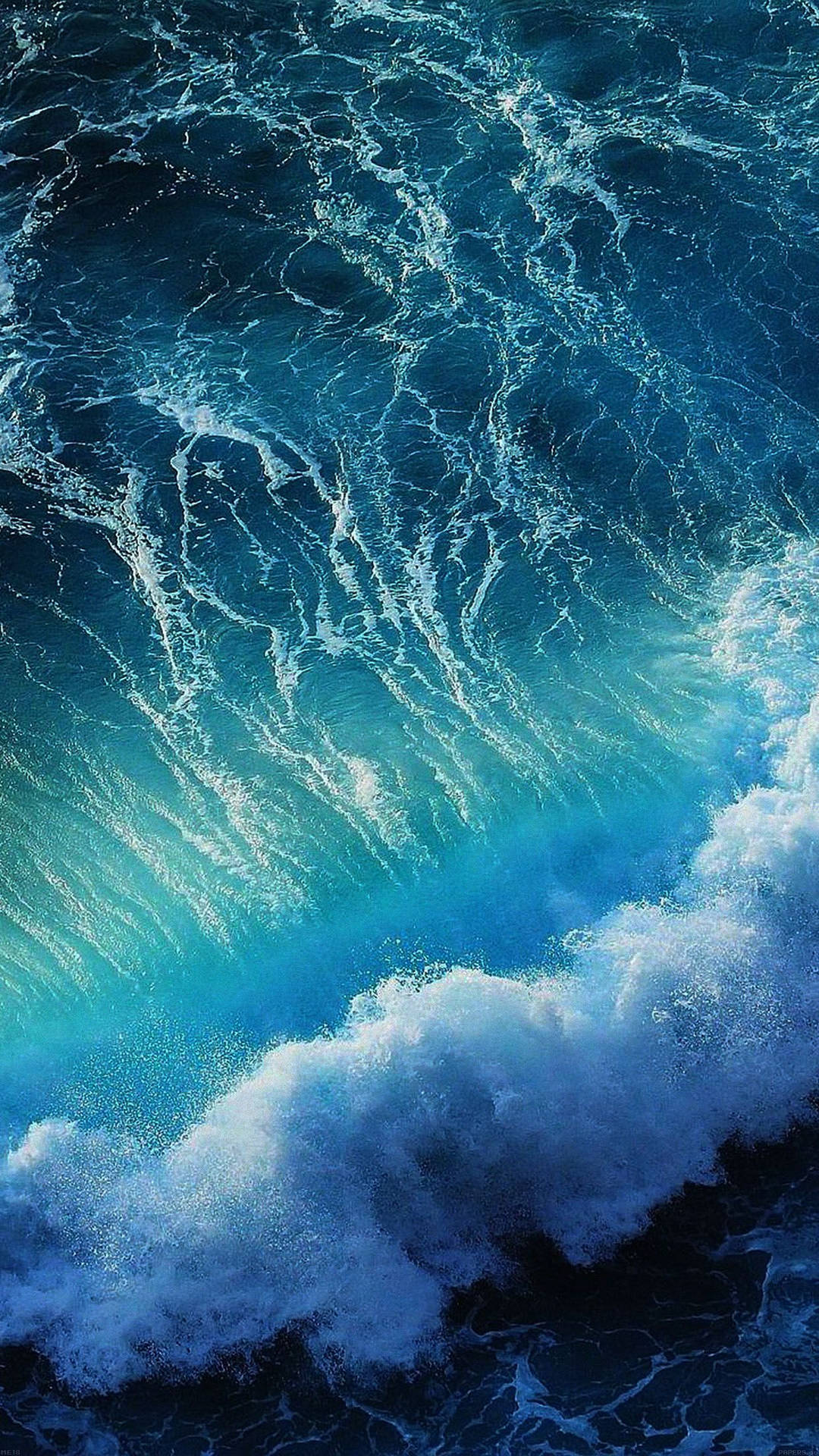 一道高聳的海浪，帶著藍綠色海水和白色泡沫向下衝擊。