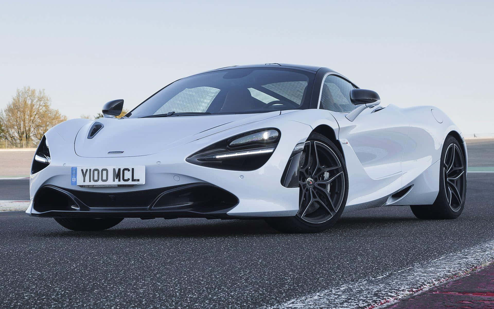 白色McLaren 720S跑車在賽道上，配備黑色輪圈和空氣動力學設計。