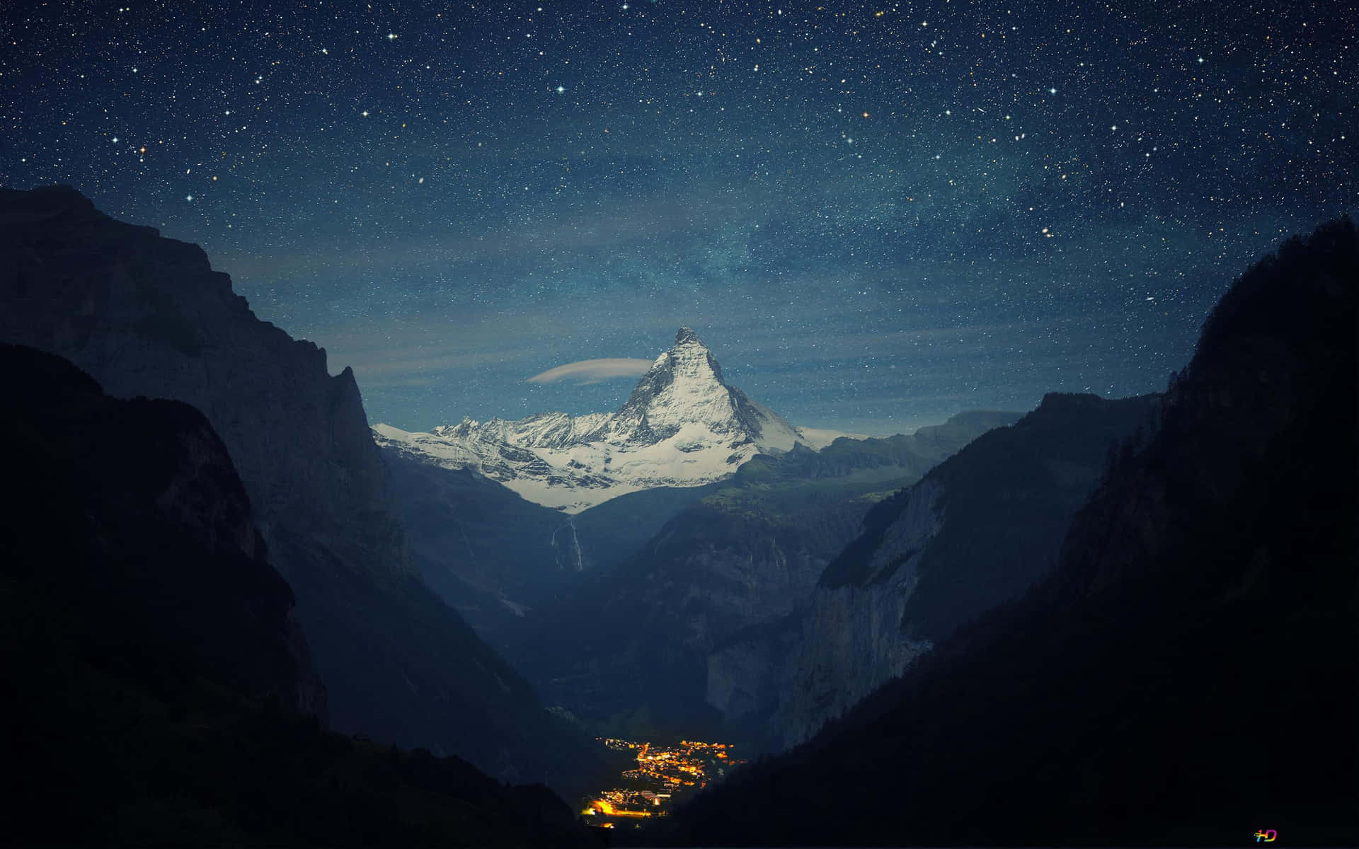 白雪皚皚的馬特洪峰在星空下，山谷中閃爍的村莊。