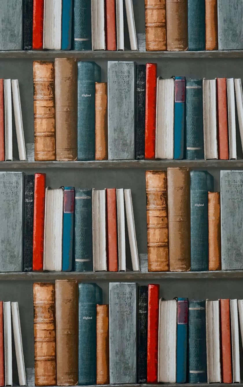 一排排復古書籍，帶有磨損的書脊，放在深色木架上。