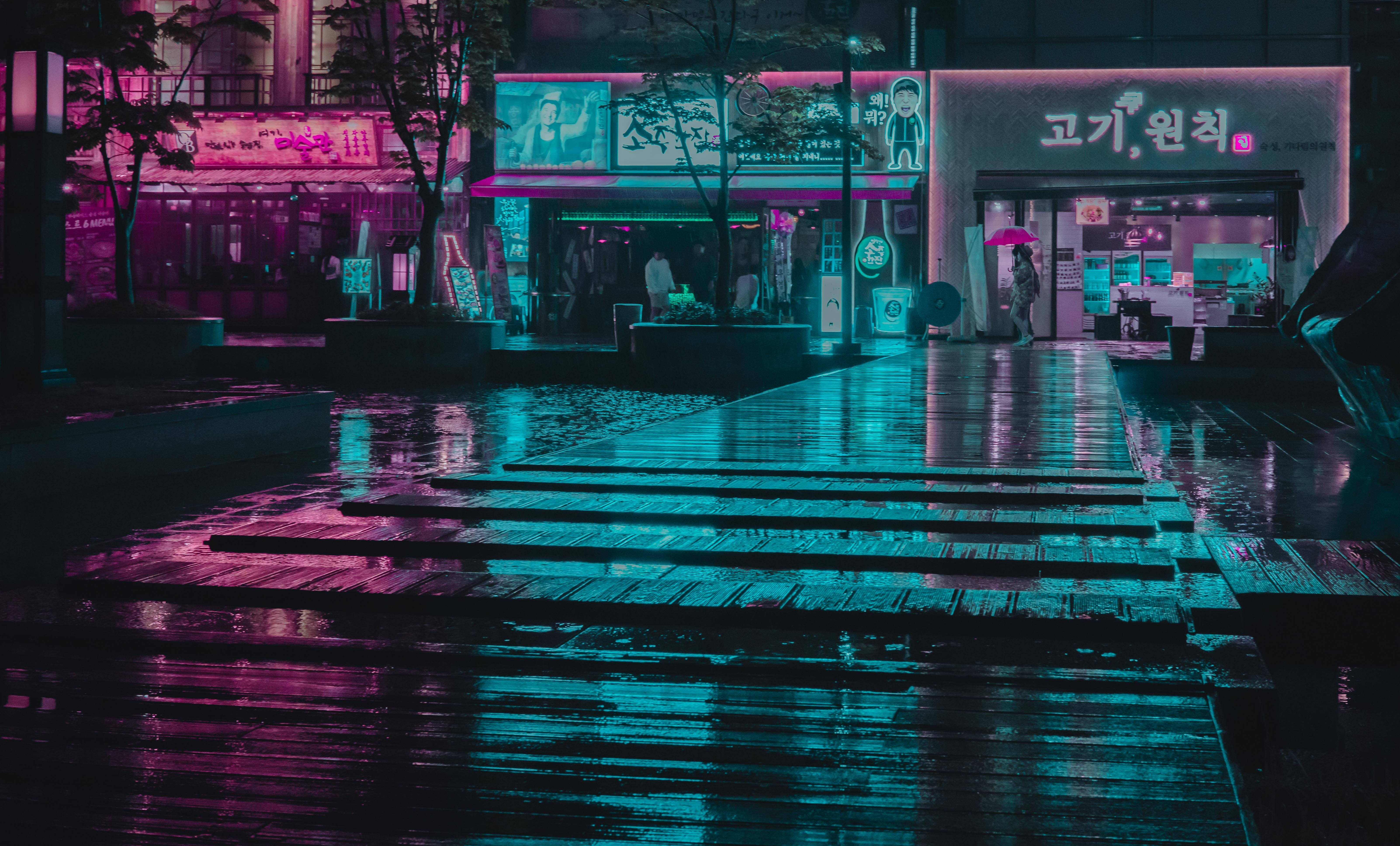 蒸氣波 桌布 壁紙 — 雨濕的夜間城市街道反射著發光店面和招牌的霓虹粉紅與青色燈光。