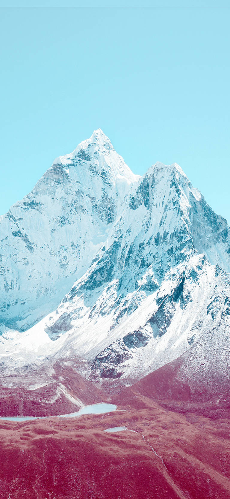 藍天下雪山山峰與粉紅色山谷