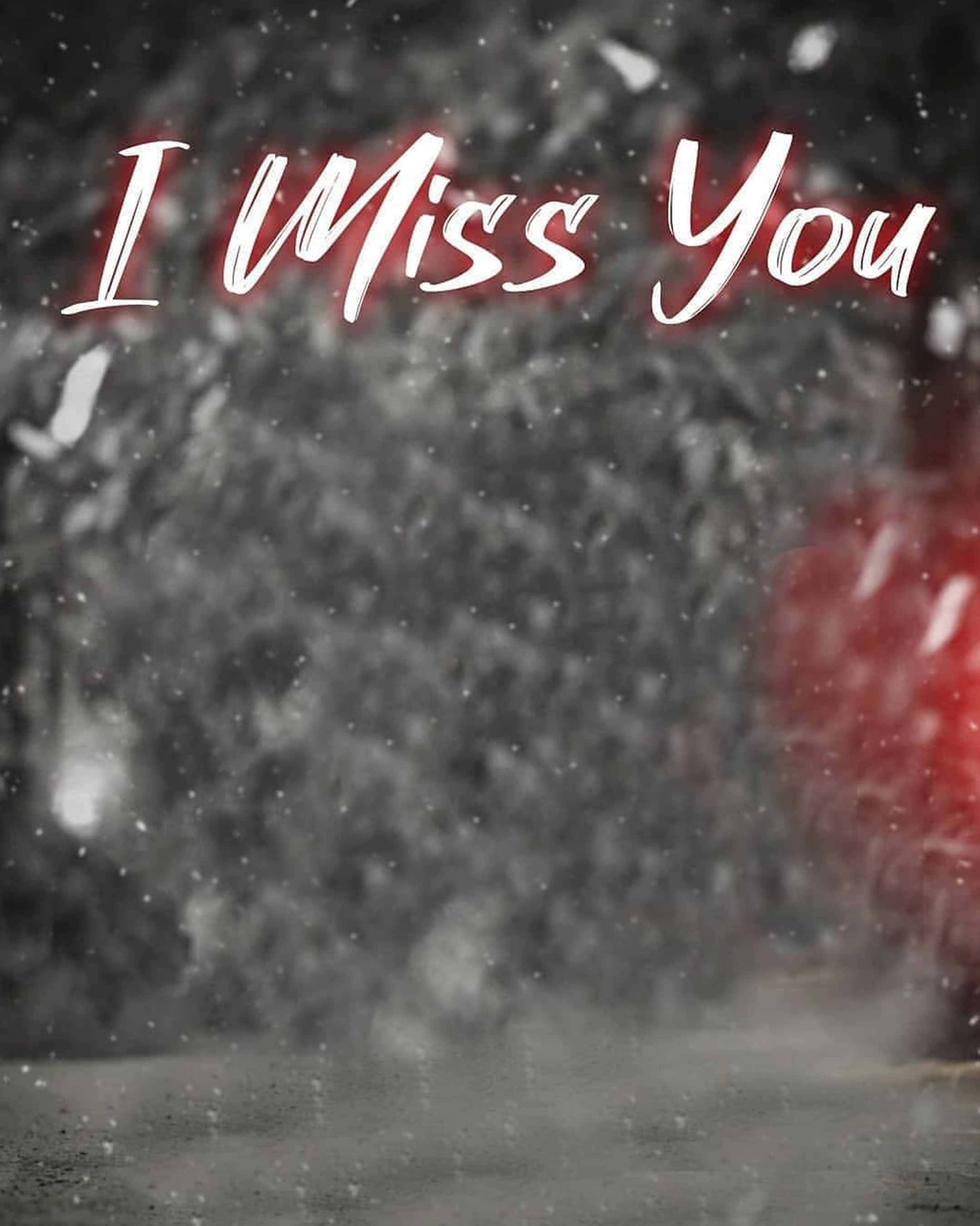 I Miss You 桌布 壁紙 — 雪花輕輕飄落在模糊的冬日街道上，發光的紅色文字在陰鬱的灰色背景上寫著「I Miss You」。