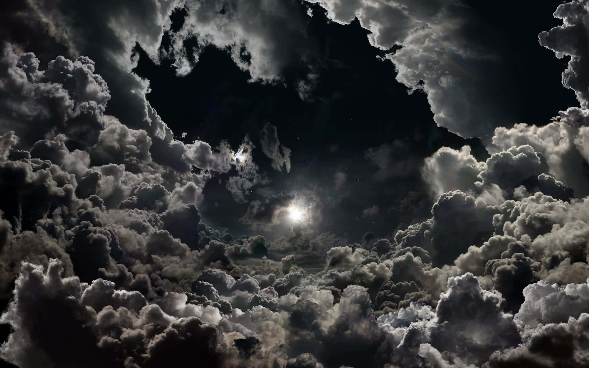 月光穿透黑暗夜空中的厚厚雲層。