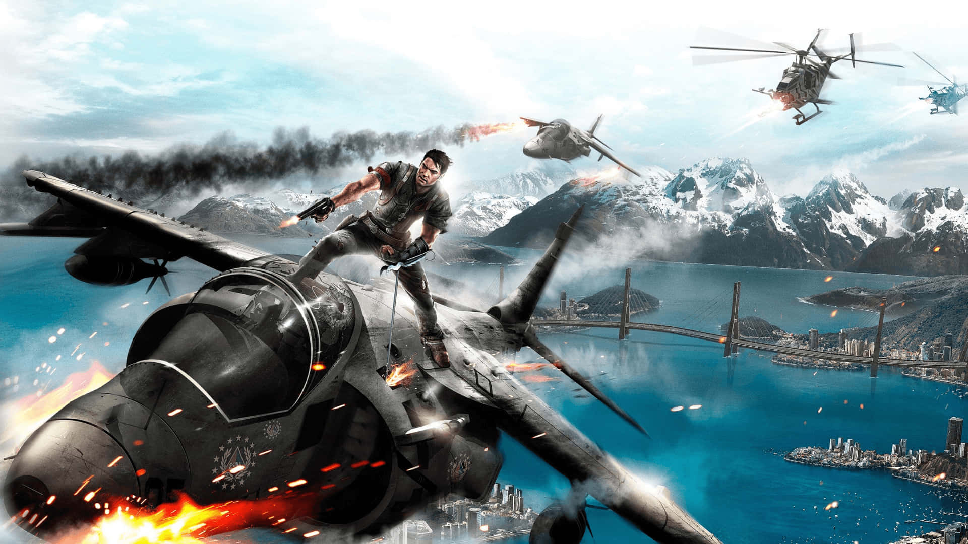 震撼的Just Cause 4遊戲場景 壁紙 — 一名士兵挑釁地站在燃燒的噴射機上，直升機和爆炸在沿海城市上空肆虐，背景是白雪覆蓋的山脈。
