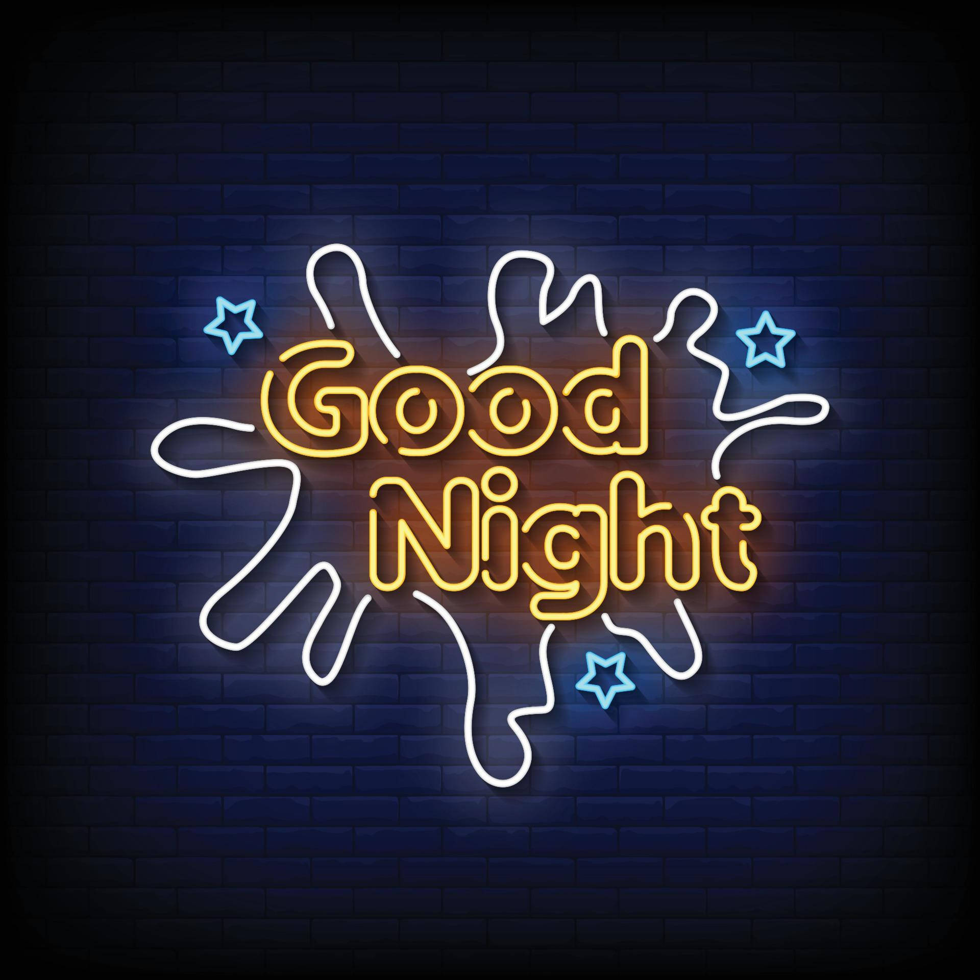 霓虹燈安眠 壁紙 — 一個鮮豔的霓虹燈牌，上面寫著黃色的「Good Night」，帶有藍色星星和白色漩渦，在深色磚牆上發光。