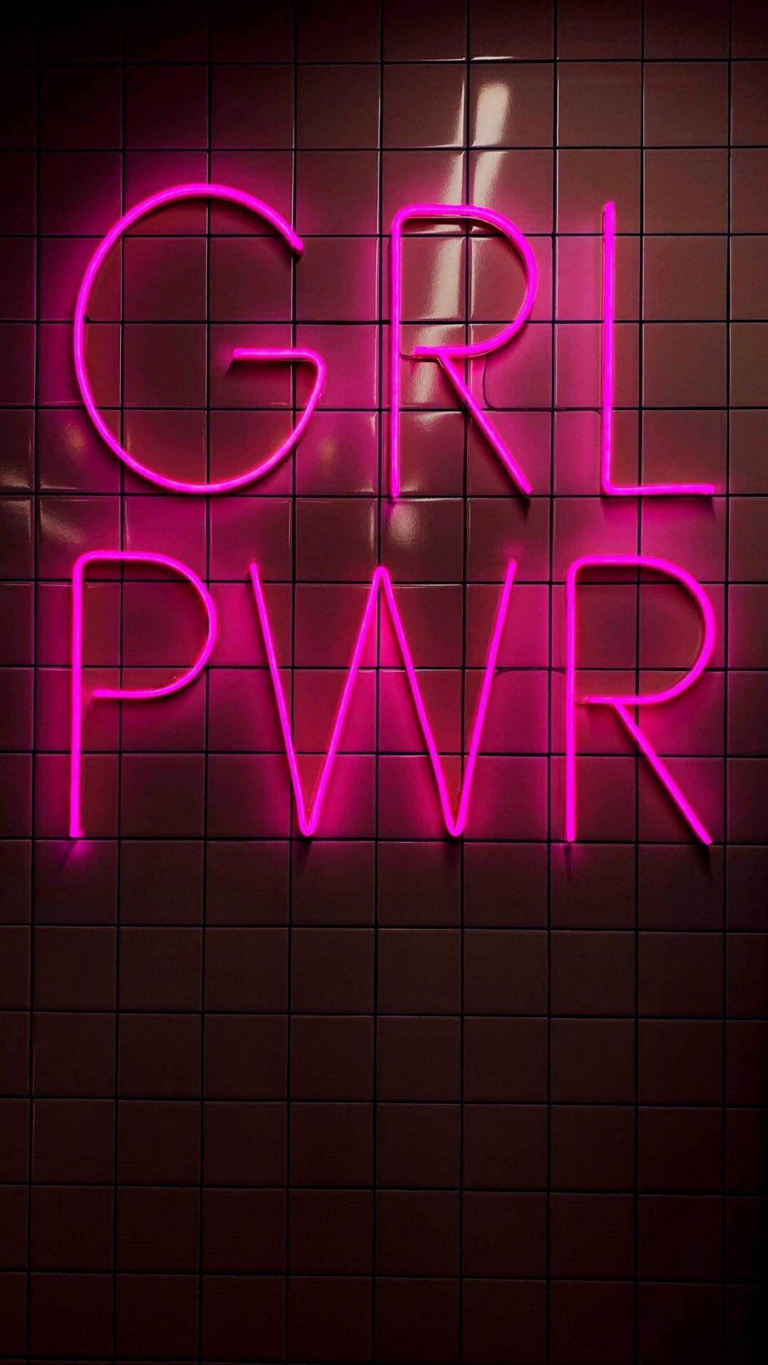 深色瓷磚牆上顯示 GRL PWR 的粉紅色霓虹燈標誌。