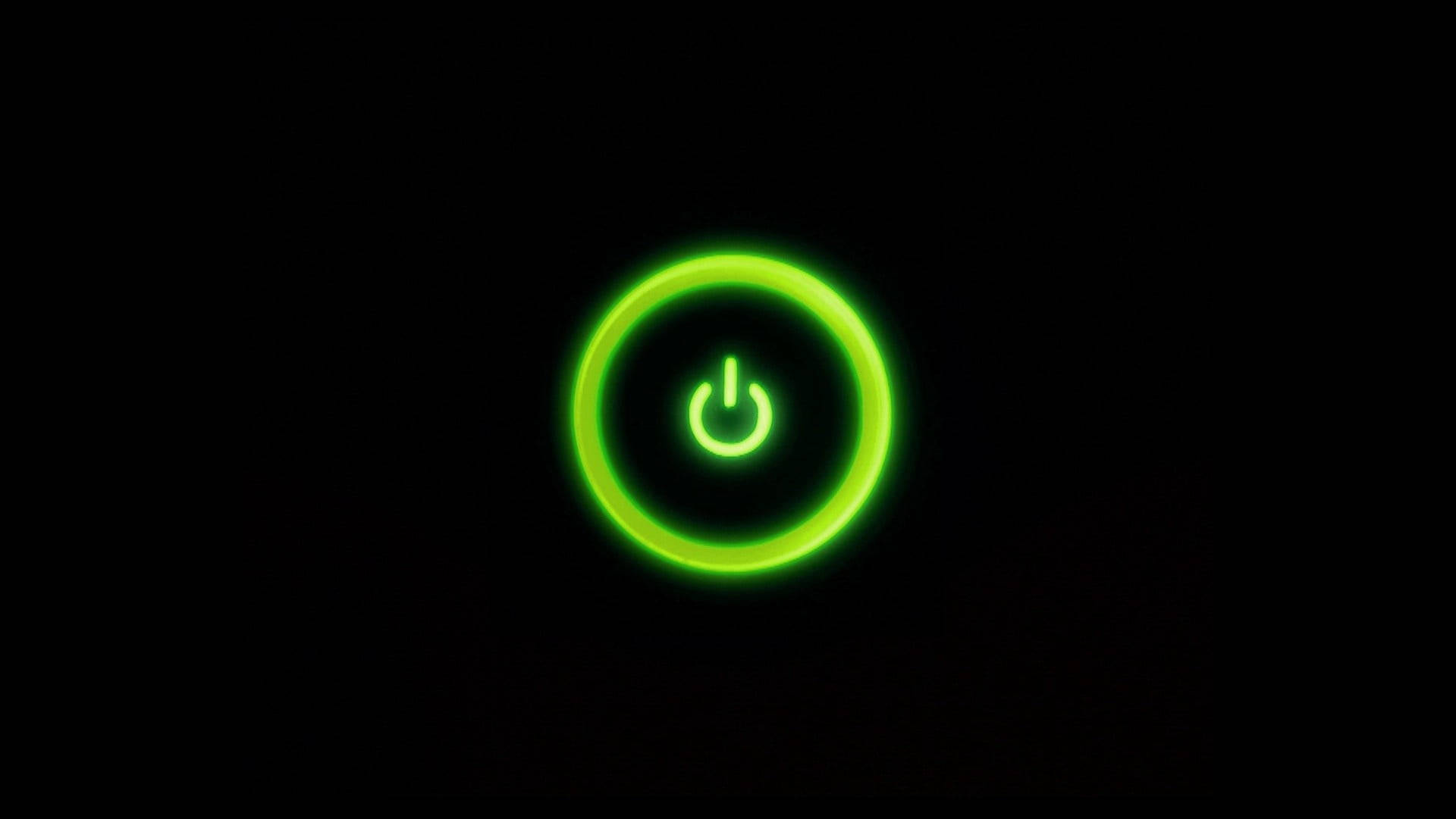霓虹綠電源按鈕 壁紙 — 一個發光的綠色電源按鈕圖標在純黑色背景上柔和地脈動。