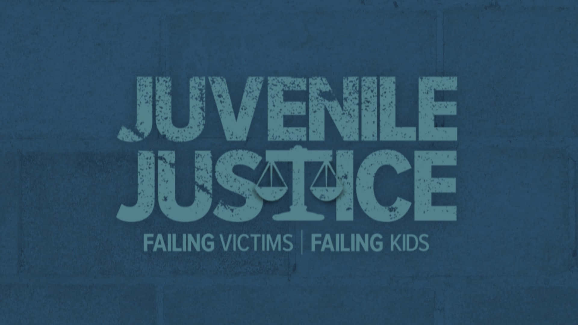 磚牆上的文字顯示 juvenile justice failing victims failing kids。