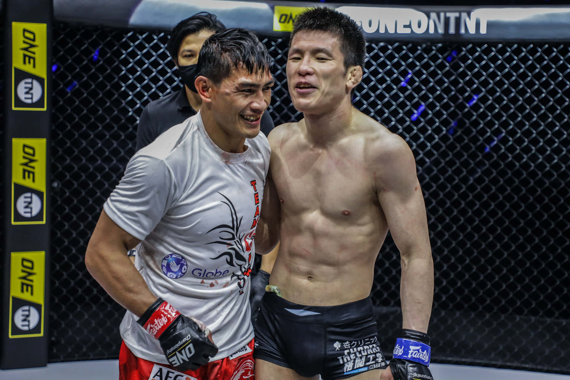 兩名微笑的MMA拳手在籠中賽後