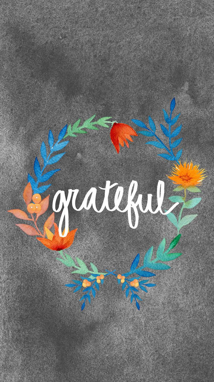 一個色彩繽紛的水彩花環，中央放置「grateful」這個詞，背景為有紋理的灰色。