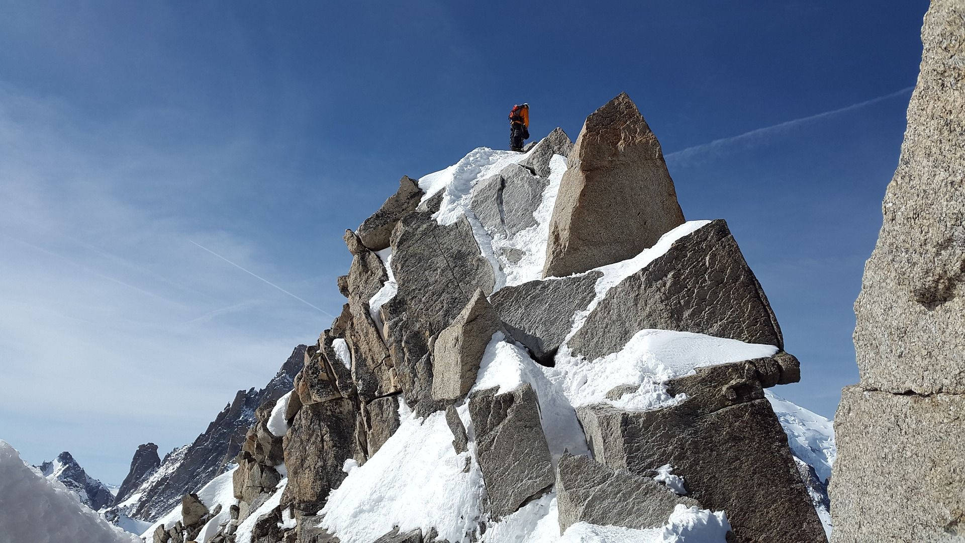 藍天下雪峰上的登山者