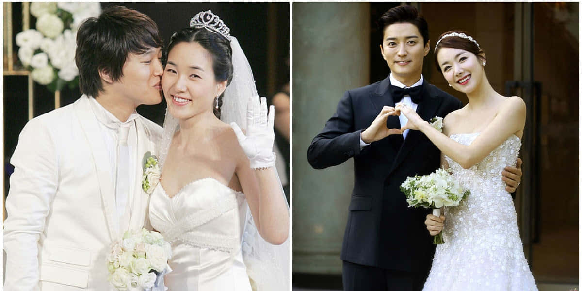 幸福的新娘和新郎以心形手勢擺姿勢拍攝婚紗照。