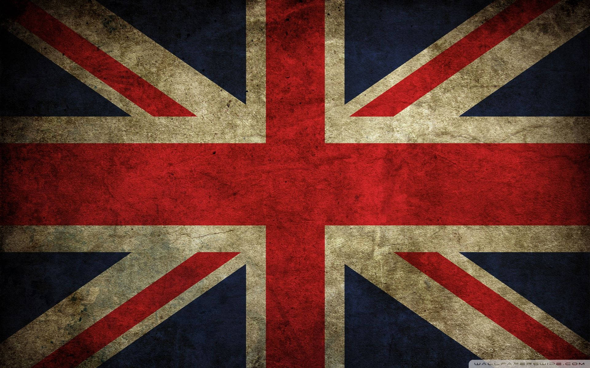 風化英國國旗 壁紙 — 一面風化的英國國旗，帶有褪色的紅、白、藍色，顯示出可見的紋理和污垢。
