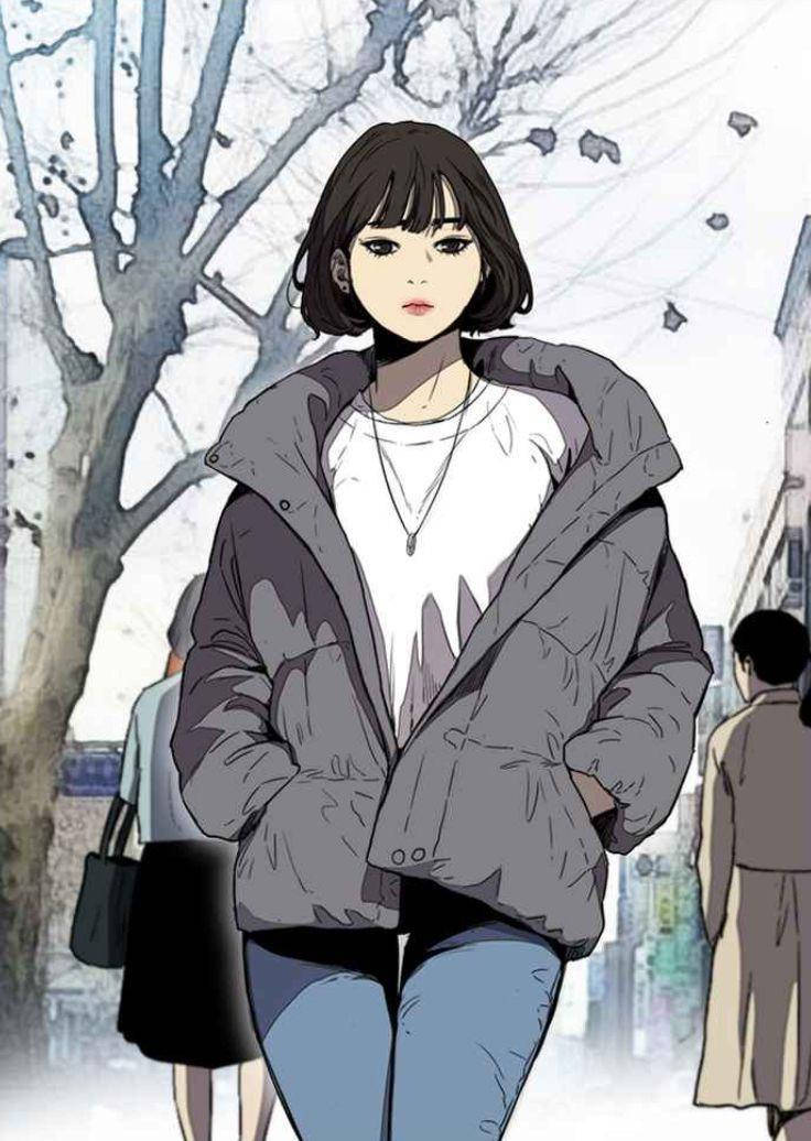 一位年輕女性在冬天穿著灰色外套走在積雪的城市街道上。
