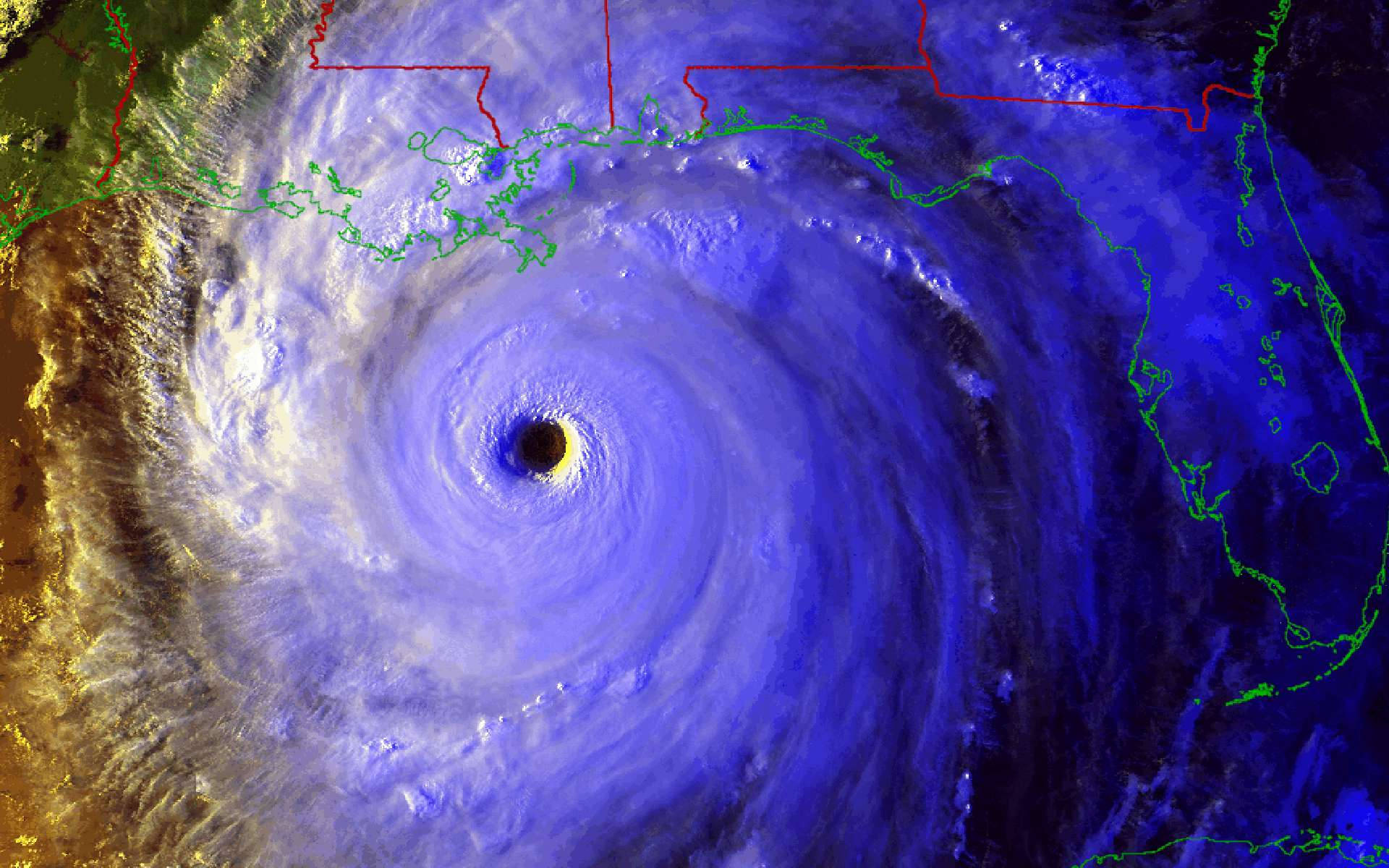 颶風鳥瞰視角 壁紙 — 一場帶有黑暗風眼的巨大颶風在墨西哥灣沿岸旋轉，伴隨著旋轉的藍色和白色雲層。