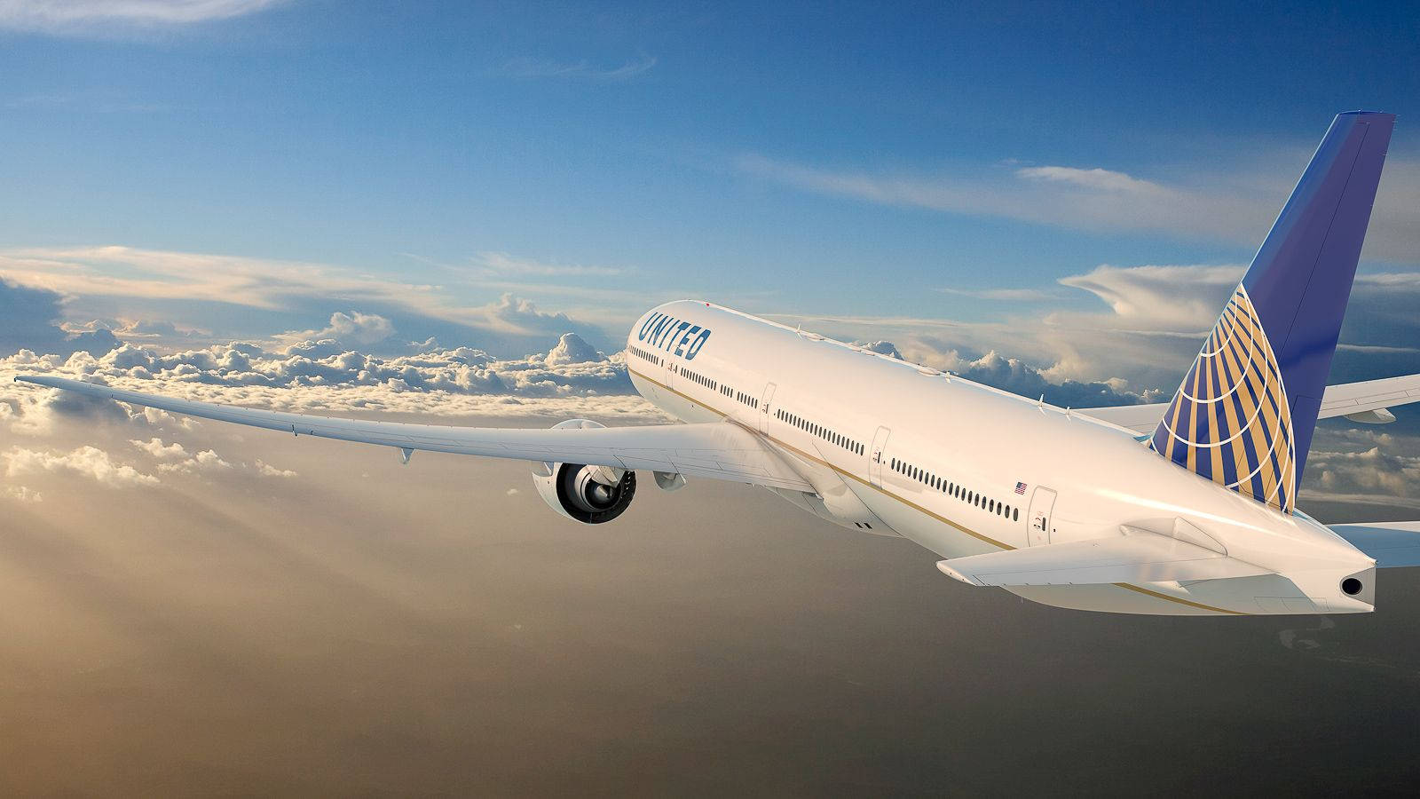 聯合航空飛機在明亮藍天的雲層上方飛行