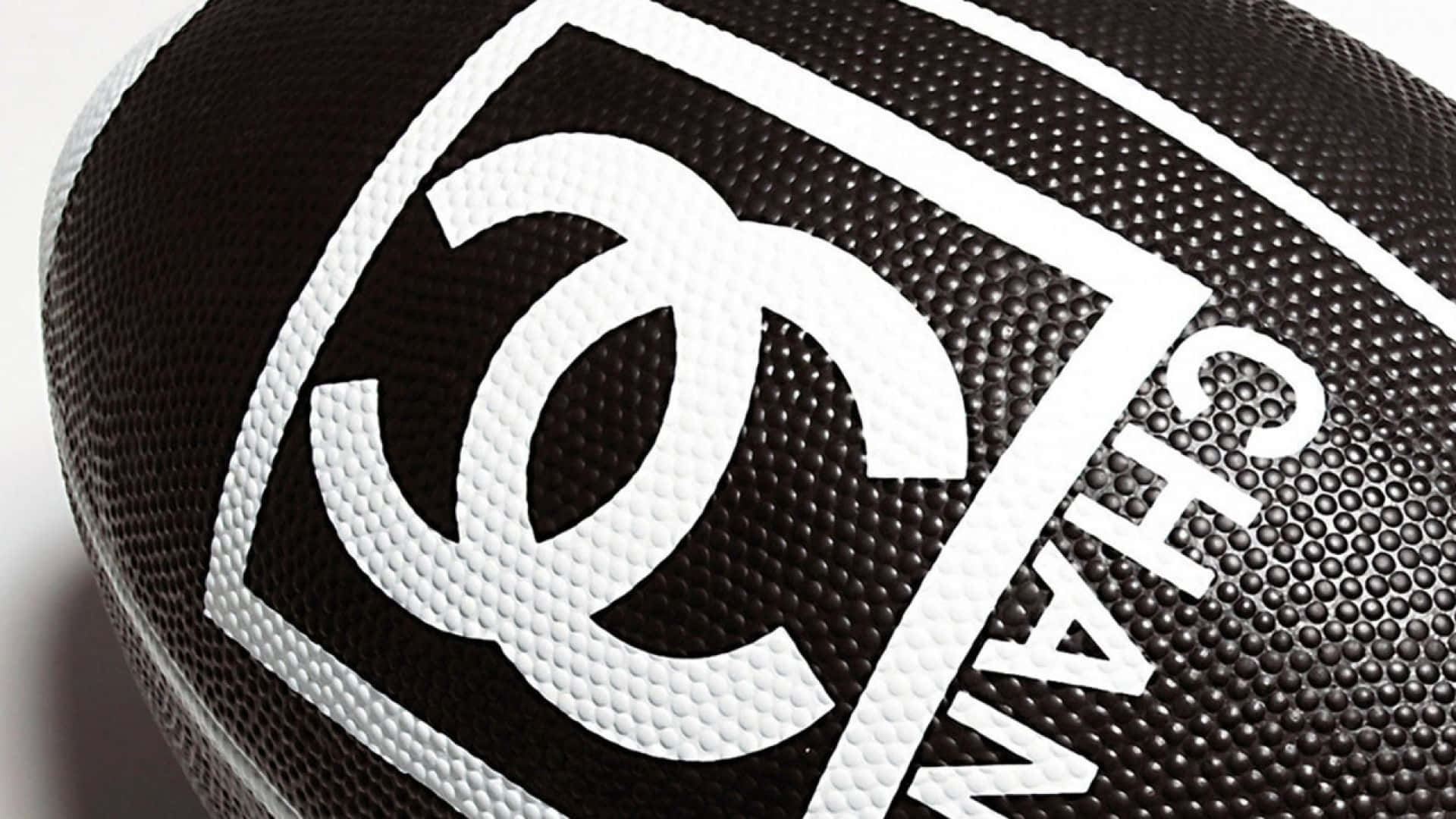 黑色足球，上面有白色 Chanel 標誌同文字。