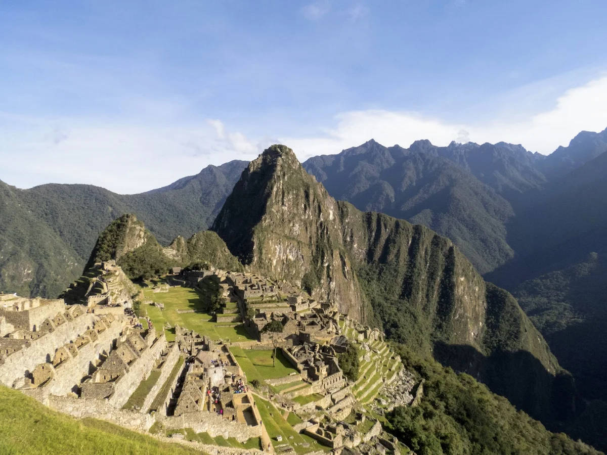 馬丘比丘的古代印加遺址，被綠色山脈和藍天環繞。