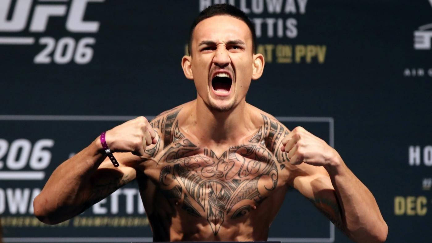 有胸口紋身的UFC拳手在稱重活動中咆哮。