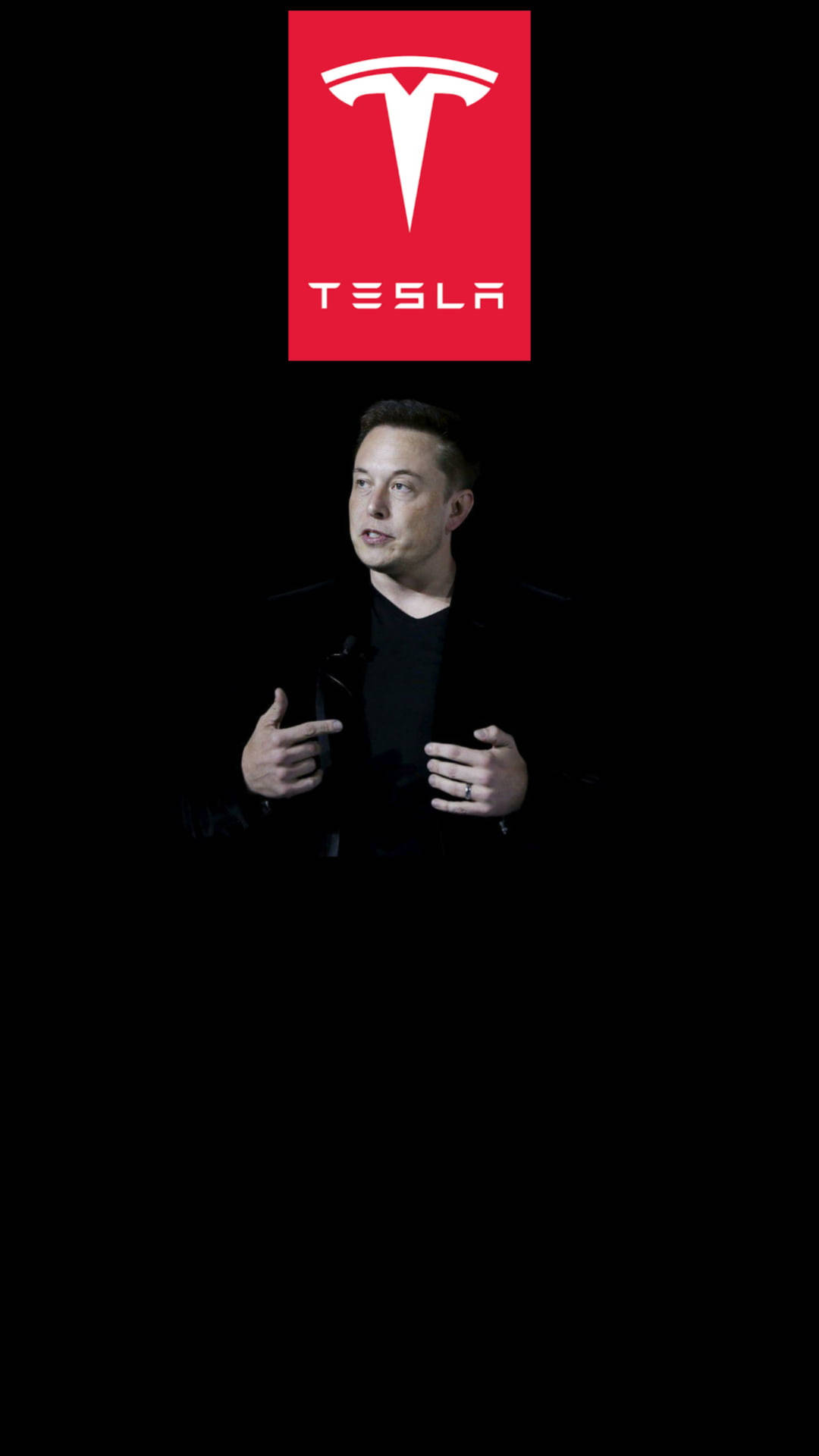 伊隆·馬斯克在Tesla活動中發言，公司標誌在他上方。 — 馬斯克 壁紙