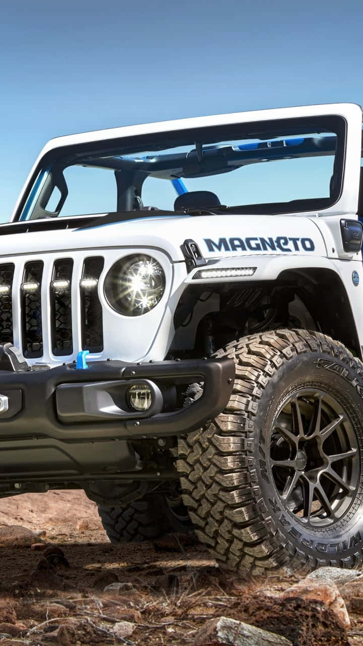 藍天下岩石沙漠地形上的白色Jeep Wrangler Magneto
