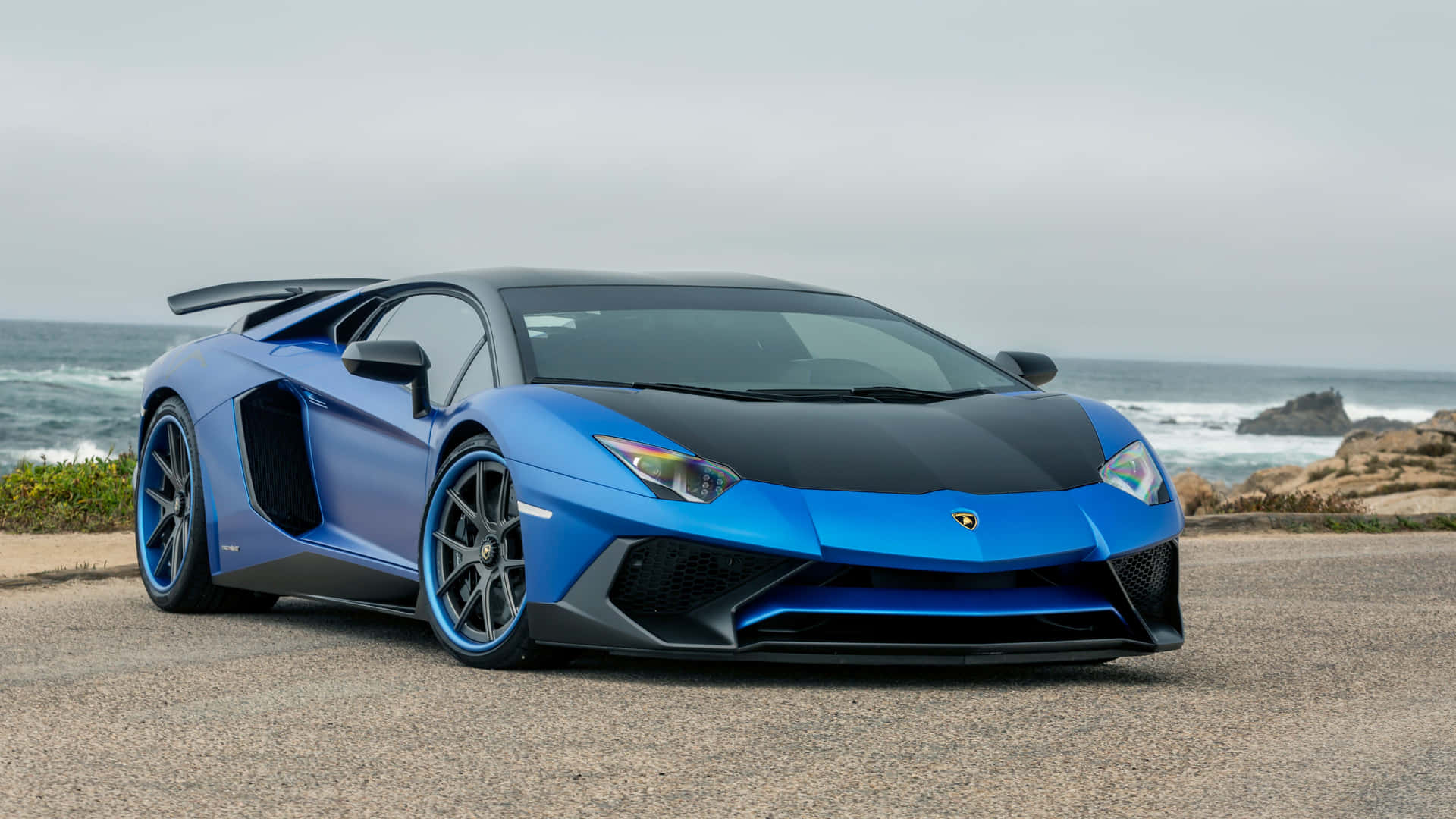 藍色林寶堅尼Aventador停泊在海洋海岸邊。