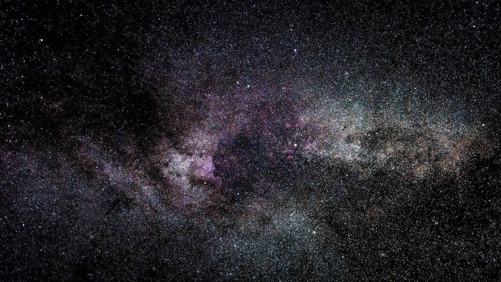 銀河系中充滿活力的紫色和藍綠色星雲，以及夜空中無數的星星。