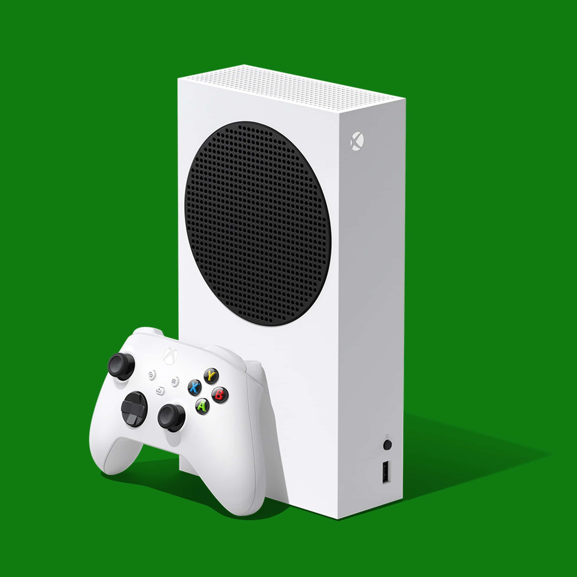 綠色背景上的白色Xbox Series S主機和控制器