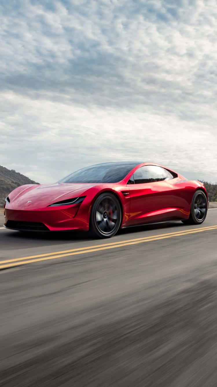 紅色Tesla Roadster在山路上飛馳，帶有動態模糊效果。