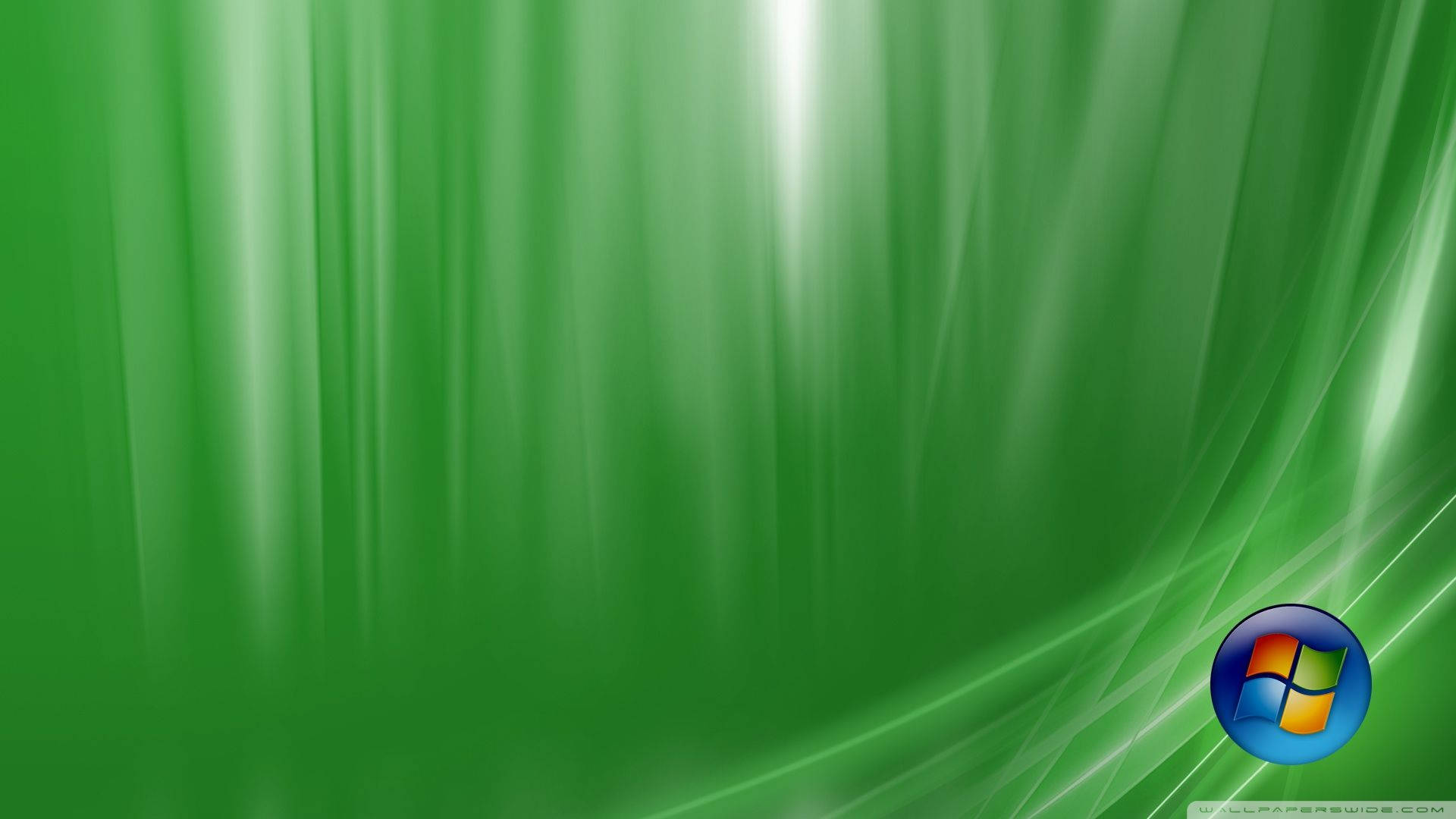 高草Windows Vista 壁紙 — 充滿活力的綠色抽象壁紙，帶有流動的光條和角落的Windows標誌。
