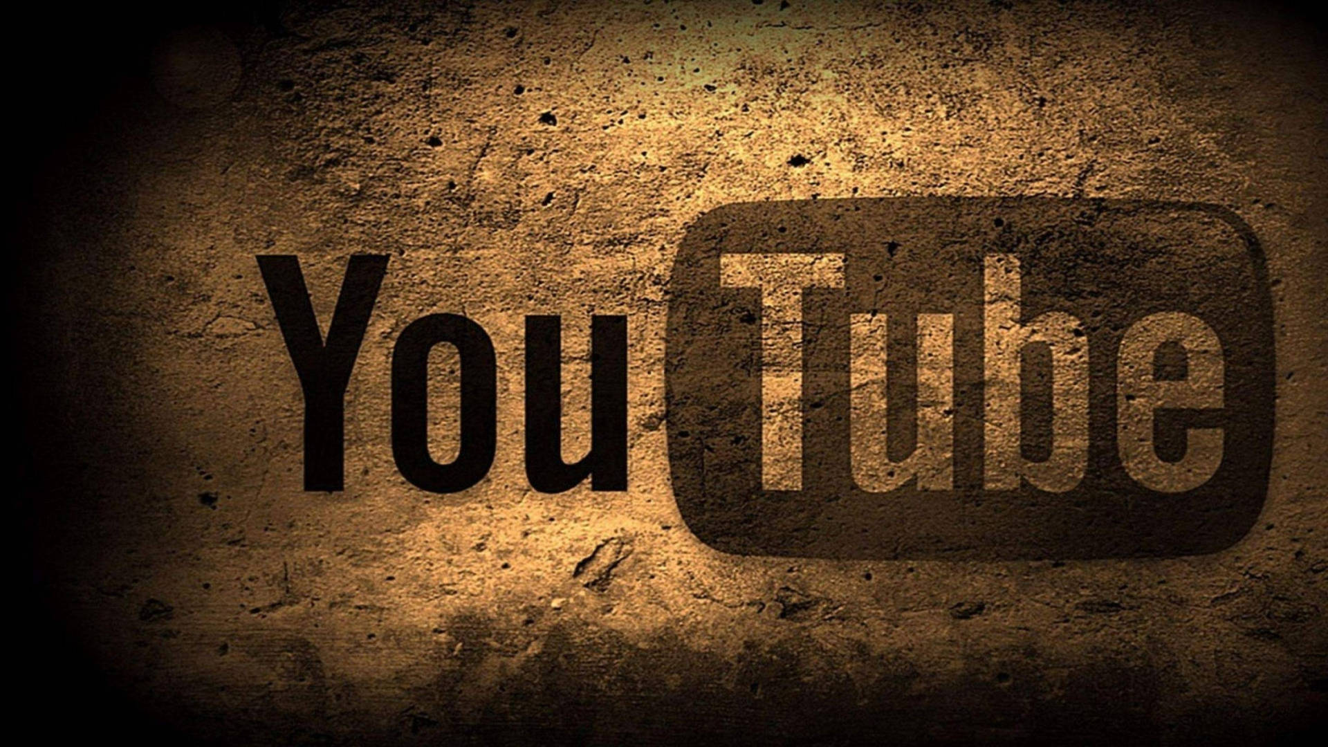 YouTube 標誌在粗糙的混凝土牆上，帶有聚光燈和暗邊。