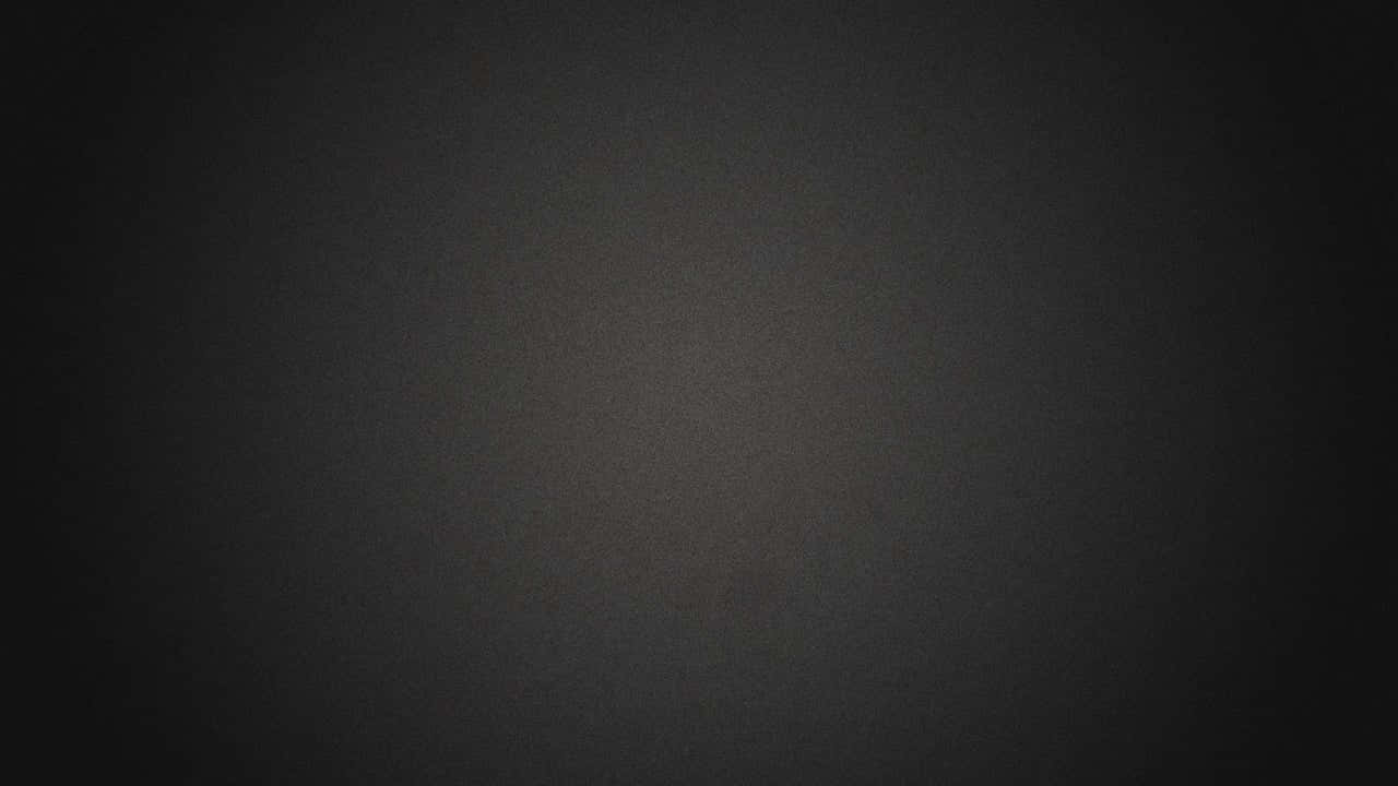帶有柔和中心光的深灰色紋理漸變背景。