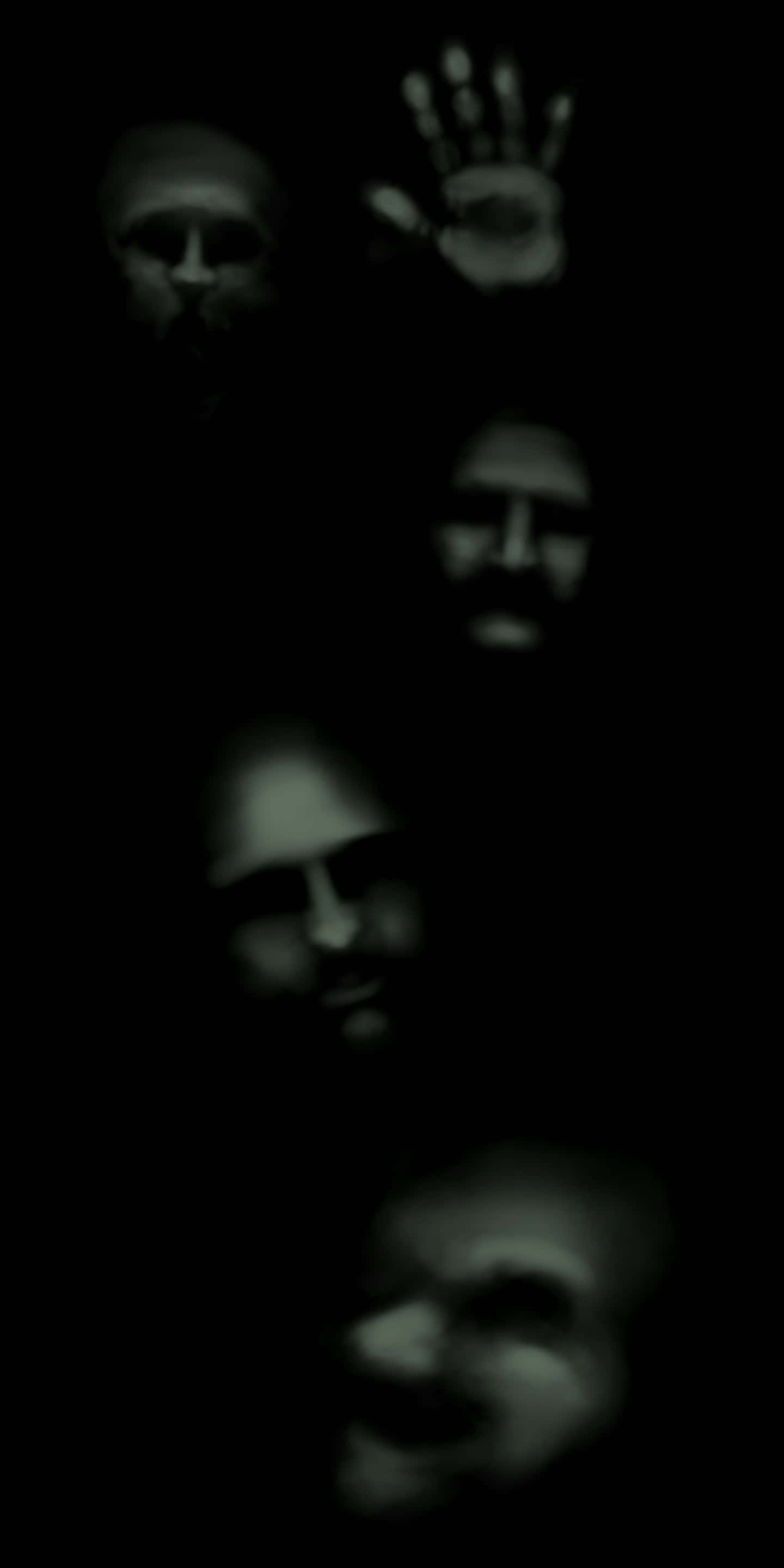 Dark Spirit 桌布 壁紙 — 鬼魅般的面孔和一隻手在黑暗中漂浮，散發著詭異的綠色光芒。